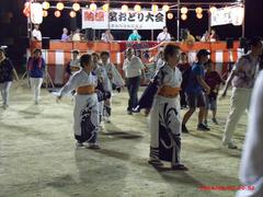 Bon Odori dancer performing traditional dance in vibrant kimono during 2024 summer festival at Imazu, Osaka