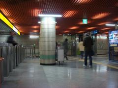 Mia Station exterior with overcast sky and railway tracks