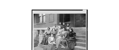 African American students seated on steps outside a building at Fisk University
