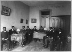 Nine young black men seated around two small tables at the Extempo club of Fisk University, Nashville, Tennessee