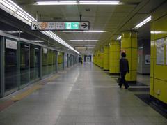 Platform at Garak Market Station on SMRT Line 8 with waiting passengers and signage