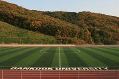 Sports grounds of Dankook University with green fields and running tracks
