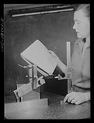 Class in the use of precision instruments with students testing machined part angles using sine bars and vernier height gauges at New York University