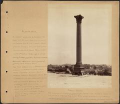 Pompey's Column in Alexandria, ancient red granite monument with Corinthian capital.