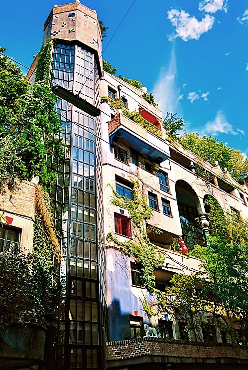 Colorful Hundertwasserhaus apartment building with organic shapes and greenery in Vienna Austria