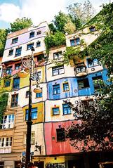 Hundertwasserhaus colorful apartment building featuring unique, irregular shapes and vibrant colours in Vienna, Austria