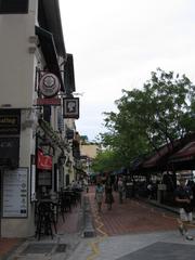 Boat Quay in Singapore with colorful shophouses and boats along the river