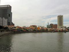 Boat Quay waterfront with traditional shophouses and boats along the Singapore River