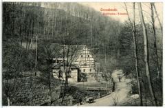 Historic black and white photograph of Cossebaude Waldfrieden Talmühle area with a bridge and buildings from 1911