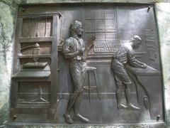 Relief sculpture at the base of the Benjamin Franklin statue in Old City Hall, Boston