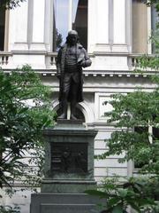 Street view of a historic building in Boston with flag and multiple windows