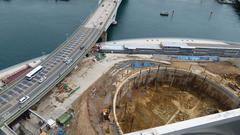 Construction site of Busan Lotte Tower with cranes and building framework