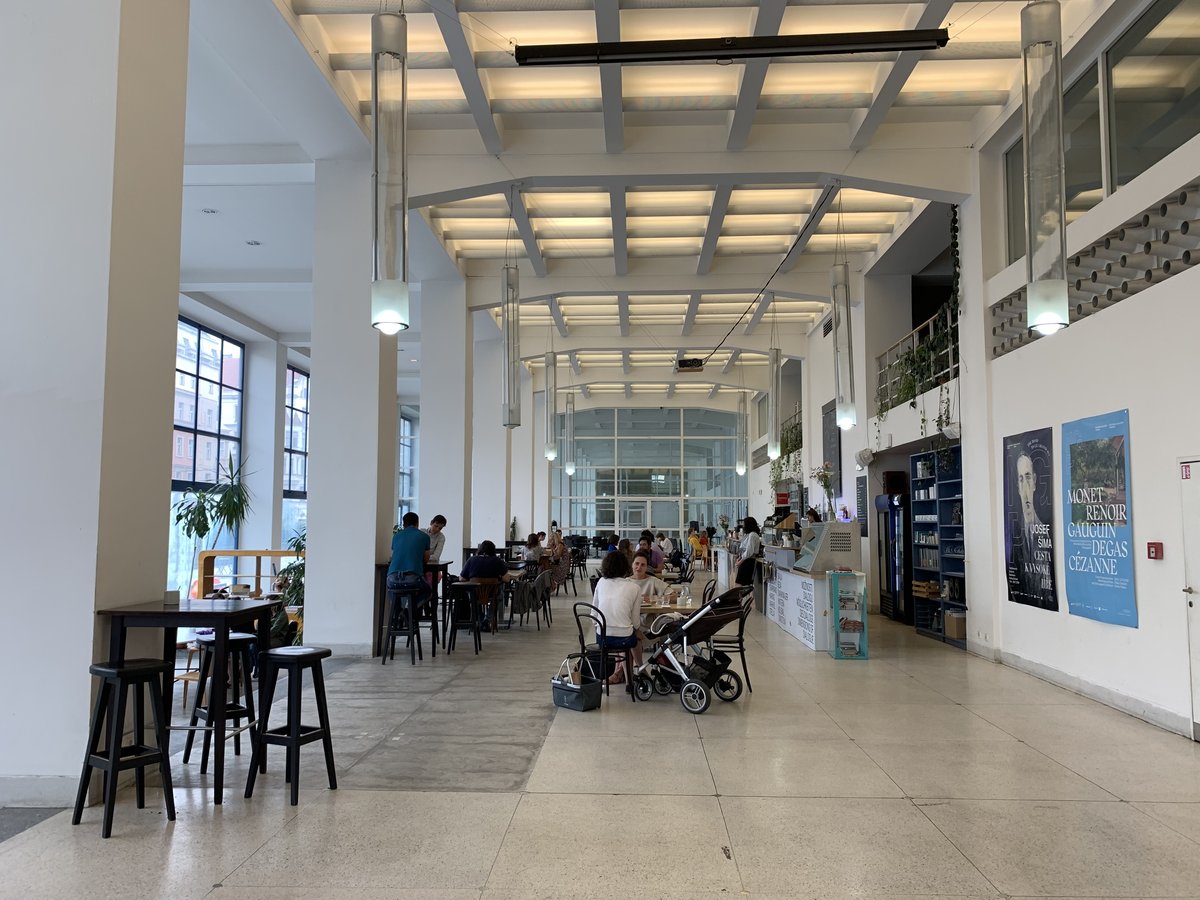 Interior view of Cafeteria du Veletržní palác in Prague with modern seating and decorative wall