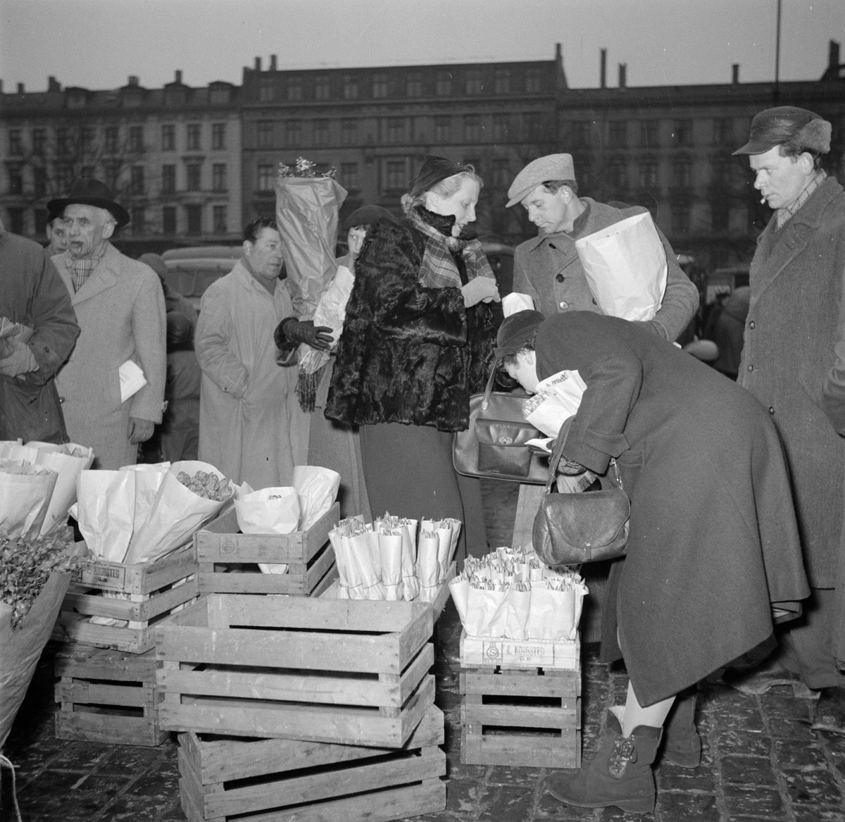 Visitors browsing flowers and goods at the flower market in Copenhagen, 1954