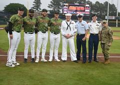 U.S. Coast Guard, Air Force, Army, and Navy personnel with Norfolk Tides Baseball players after throwing first pitch on Armed Forces Day 2024