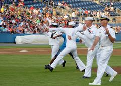 Military representatives throwing the first pitch at Norfolk Tides baseball game during Navy Tides Night