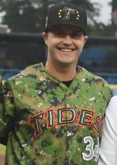 Members of U.S. Coast Guard, Air Force, Army, and Navy with Norfolk Tides Baseball players after first pitch on Armed Forces Day 2024
