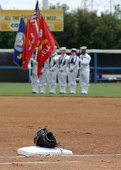 Color Guard members from USS Harry S. Truman parading the colors during the national anthem at a Norfolk Tides baseball game at Harbor Park