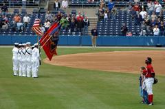 Color Guard members from USS Harry S. Truman parading colors during national anthem at Norfolk Tides baseball game