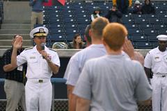 Rear Adm. James Winnefeld Jr. administering oath of enlistment to future Sailors during Military Appreciation Night at Harbor Park