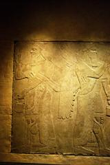 Ancient Assyrian reliefs exhibiting intricate carvings of figures and scenes