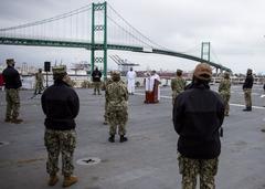 Sailors attending Easter sunrise service on flight deck of hospital ship USNS Mercy