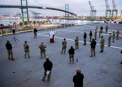 Sailors attending Easter sunrise service on flight deck of hospital ship USNS Mercy during COVID-19 response