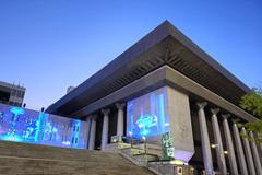 Night view of Sejong Center for the Performing Arts main hall with colonnades under Korean-style roof resembling giwa tiles
