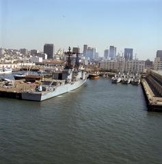 Starboard quarter view of the USS Paul F. Foster (DD-964) destroyer moored at Broadway Pier in San Diego with three Canadian Restigouche-class frigates visible to the right