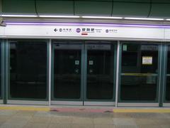 Interior of Gwanghwamun Station subway platform with passengers and train