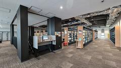 Library interior near search terminals with bookshelves and seating area