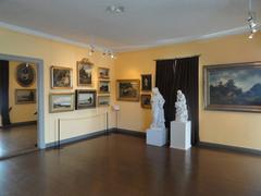 Interior view of the Cygnaeus Gallery in Helsinki, Finland showcasing classical artworks and detailed gallery architecture