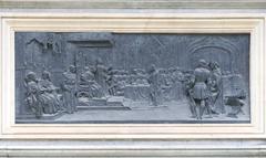 Relief sculpture of Christopher Columbus and Isabel of Castile on monument pedestal in Granada, Spain