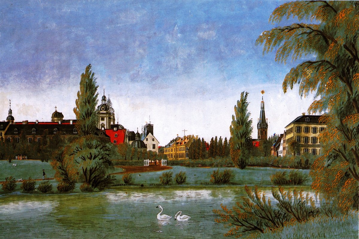 View from the Hofgarten in Düsseldorf featuring Neanderkirche, St. Andreaskirche, historic government buildings, Statthalterpalais, and Lambertuskirche