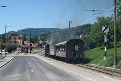 Blonay railway station with a historic steam locomotive and mixed adhesion-rack railcar in the background