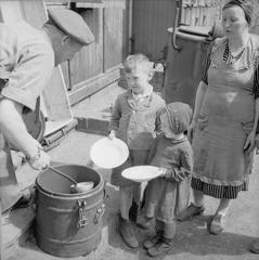 Displaced persons and refugees receiving aid and registration in a camp in Hamburg, Germany, 1945