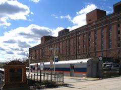 MARC combination baggage and passenger coach parked at Camden Station with B&O Warehouse in the background