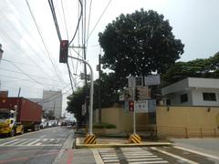 Busy street view along Bonny Serrano Avenue in Socorro, Quezon City with vehicles, buildings, and commercial establishments