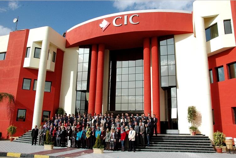 Front campus view of Canadian International College in Cairo with employees present