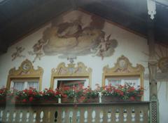 Traditional Bavarian building mural in Oberammergau depicting local cultural scenes