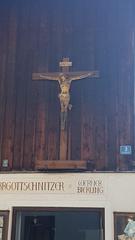 Ornate wooden house cross with religious carvings in Theaterstraße, Oberammergau