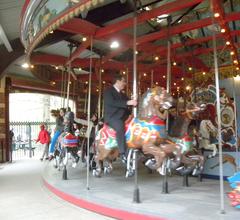 Interior view of Central Park Carousel with horses on a cloudy day
