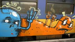 Decorated Dutch train with graffiti art at Amsterdam Central Station in winter