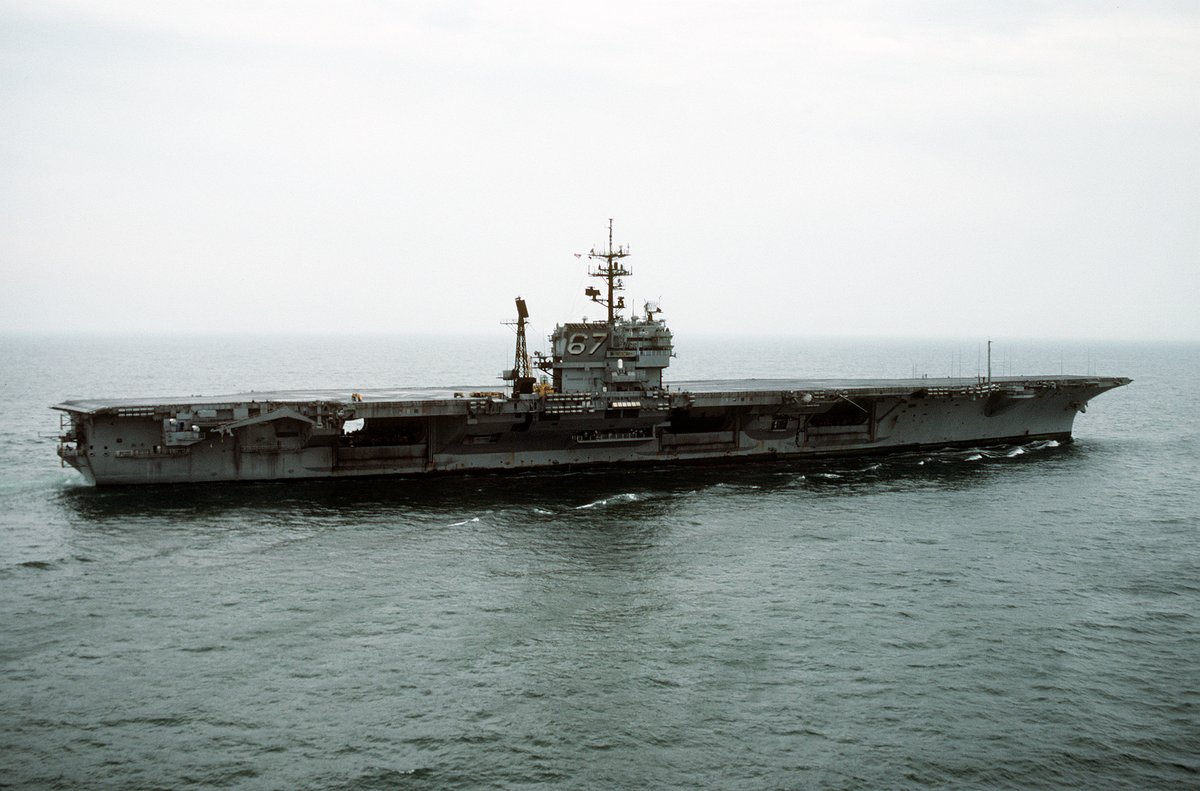 Starboard view of aircraft carrier USS John F. Kennedy (CV-67) approaching Naval Station Norfolk after Persian Gulf deployment during Operation Desert Storm