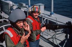 Sailor operating an M2 .50-caliber machine gun guided by a telephone talker during a Quick Draw drill aboard USS John F. Kennedy aircraft carrier
