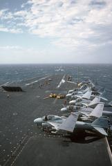 An A-6E Intruder aircraft is launched from the aircraft carrier USS JOHN F. KENNEDY (CV 67) with six A-6E Intruder and one EA-6B Prowler parked on deck edge