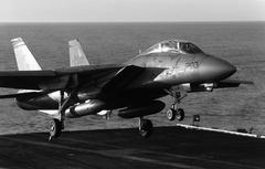 F-14A Tomcat aircraft of Fighter Squadron 32 preparing to land on USS John F. Kennedy aircraft carrier flight deck during Fleet Exercise 1-90