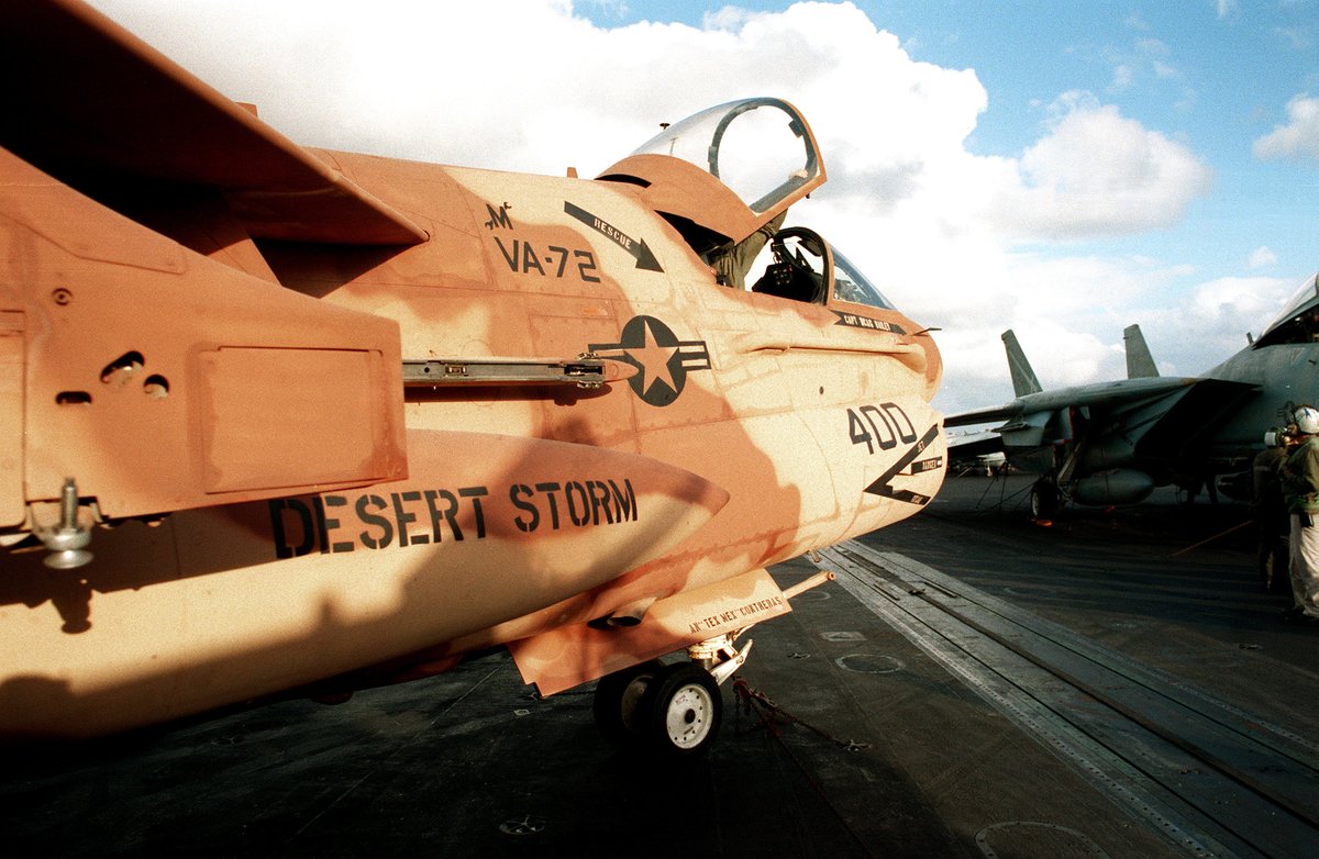 Partial right side view of an Attack Squadron 72 A-7E Corsair aircraft with desert camouflage parked on USS John F. Kennedy flight deck