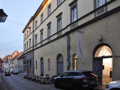 Landsberg am Lech Stadttheater building with red roof and beige facade under blue sky