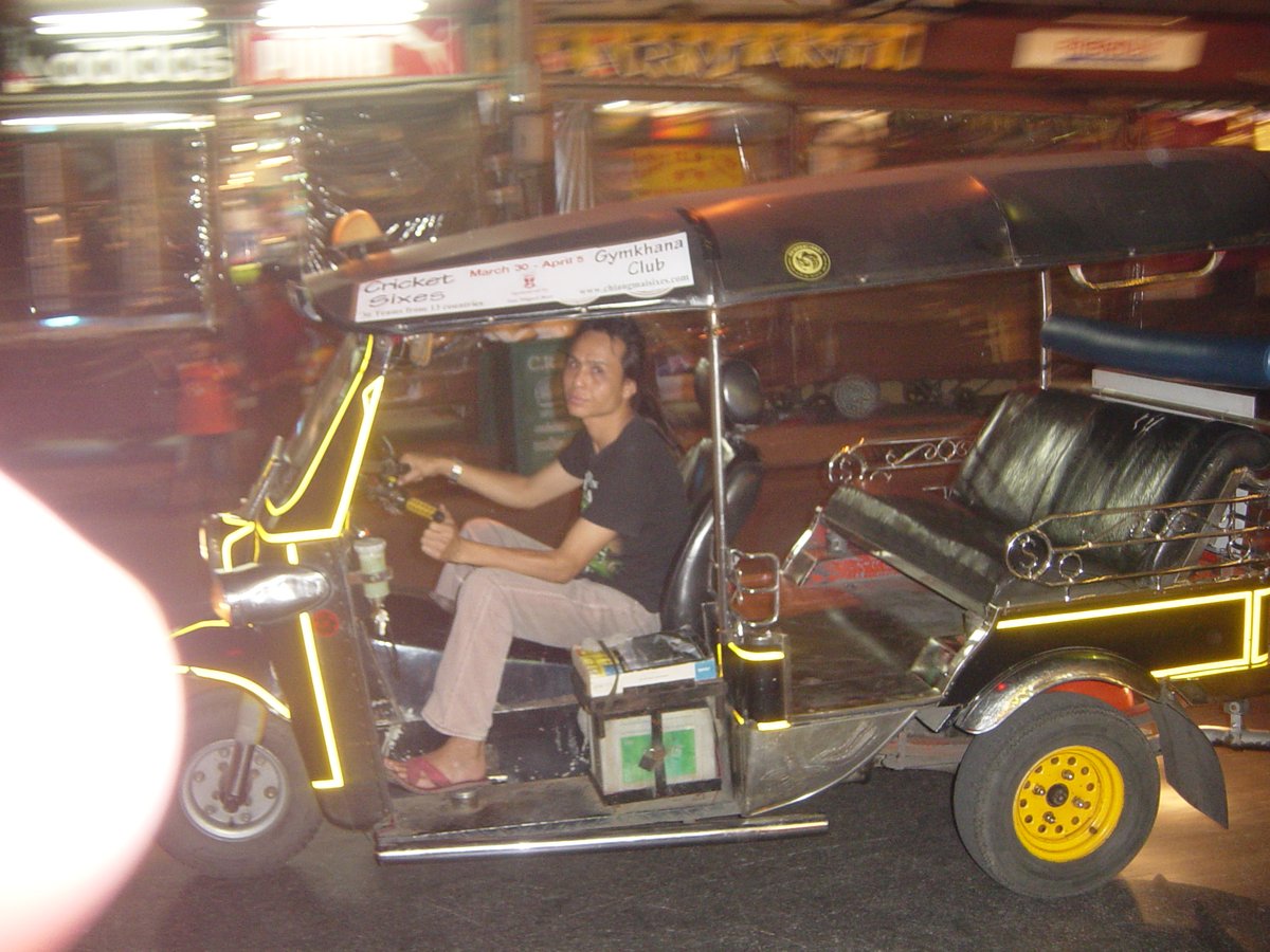 Tuk-tuk at Chiang Mai Night Bazaar at night showing vibrant market scene